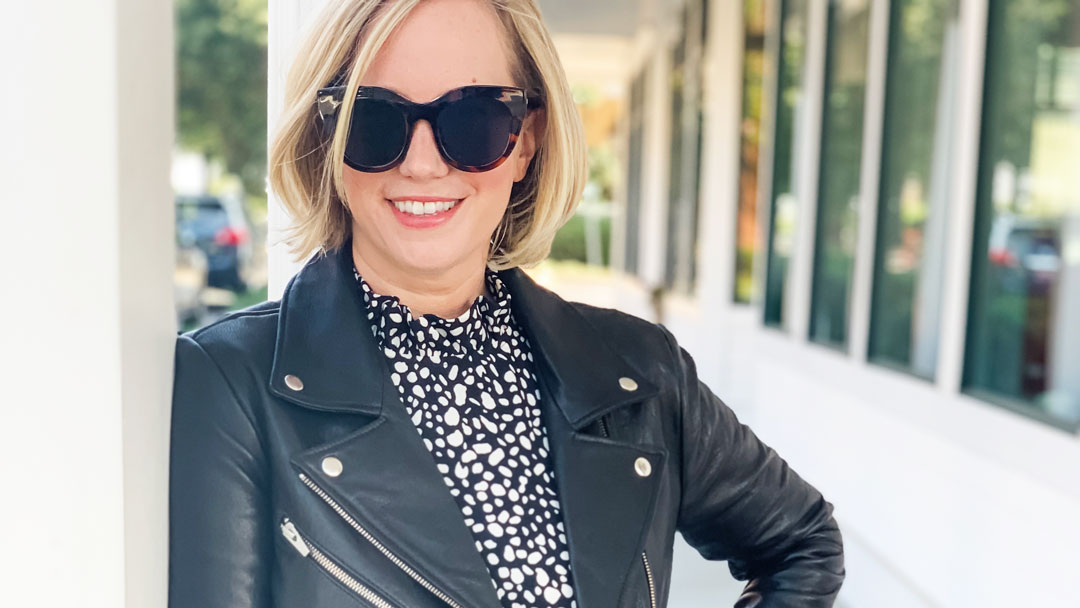 Gibson Cavallo dress black and white with black leather moto jacket and sunglasses outside