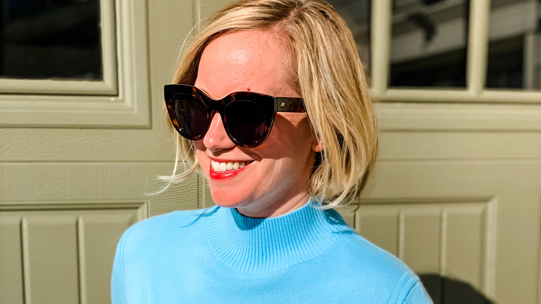 Ice blue mockneck j.crew cashmere sweater on woman in sunglasses